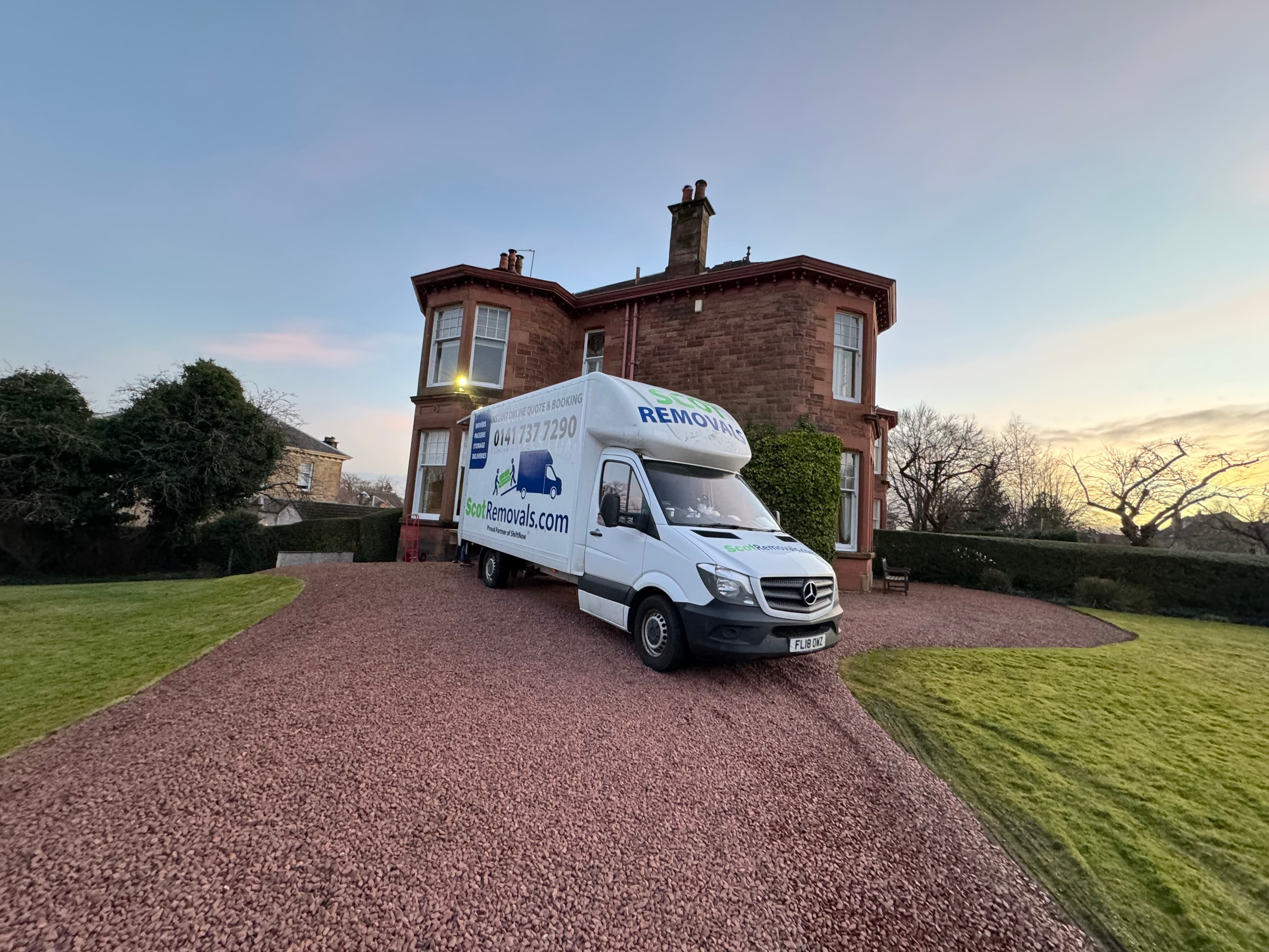 Professional removals team loading a van